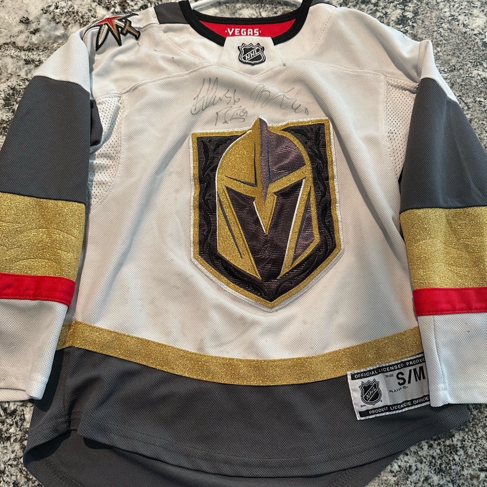 Kids autographed by several players white VGK Jersey.